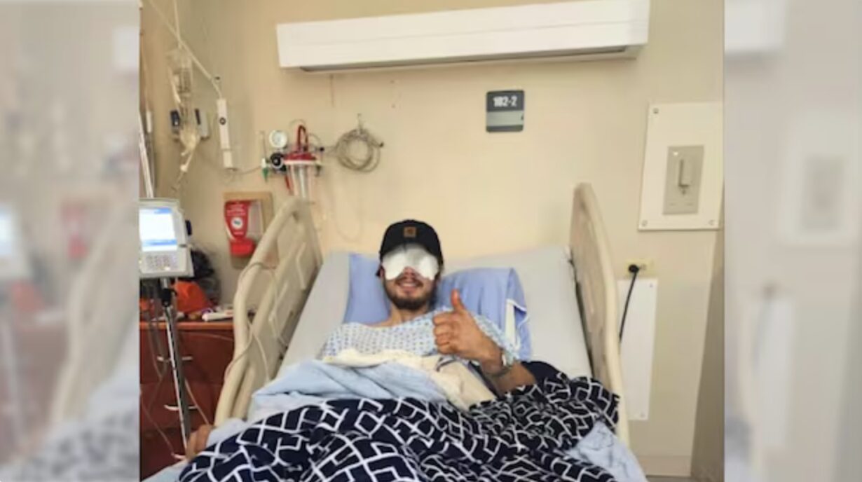 guy with eye bandages in hospital bed